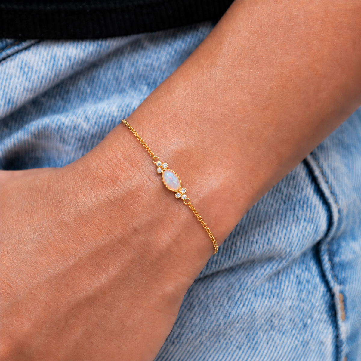 Gold opal bracelet worn on wrist